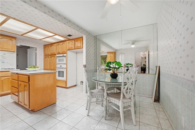 652 Via Zapata, Riverside, CA 92507 - kitchen featuring wallpapered walls, a ceiling fan, a kitchen island, light countertops, and light tile patterned floors