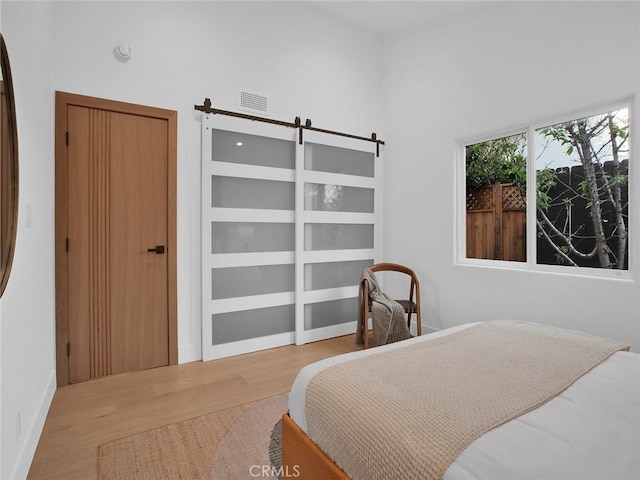 24100 Philiprimm St, Woodland Hills, CA 91367 - bedroom with wood finished floors and a barn door
