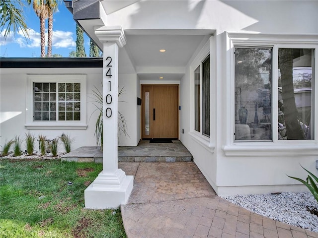 24100 Philiprimm St, Woodland Hills, CA 91367 - doorway to property featuring stucco siding