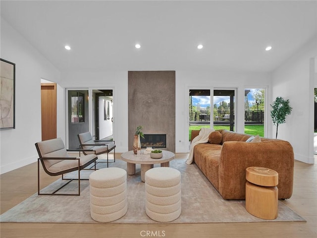 24100 Philiprimm St, Woodland Hills, CA 91367 - living room with lofted ceiling, recessed lighting, a large fireplace, and wood finished floors