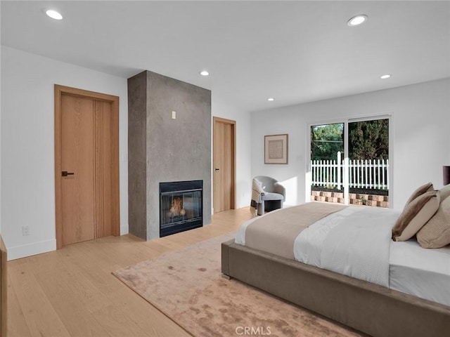24100 Philiprimm St, Woodland Hills, CA 91367 - bedroom featuring access to exterior, wood finished floors, recessed lighting, and a large fireplace