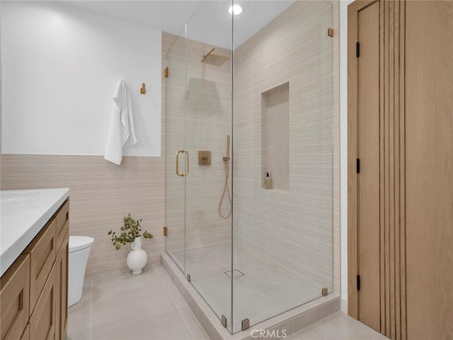 24100 Philiprimm St, Woodland Hills, CA 91367 - bathroom featuring vanity, a stall shower, tile patterned flooring, and tile walls
