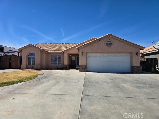441 River Vly, Blythe, CA 92225 - ranch-style house featuring concrete driveway, stucco siding, a tiled roof, and a garage