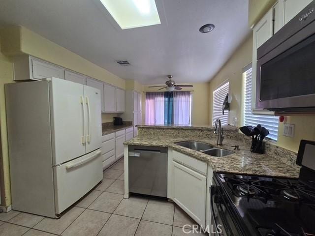 441 River Vly, Blythe, CA 92225 - kitchen featuring stainless steel appliances, white cabinets, light tile patterned floors, and light stone counters
