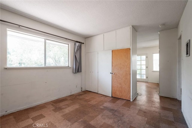 8 Coveview Dr, Rancho Palos Verdes, CA 90275 - unfurnished bedroom with a textured ceiling, light flooring, and a closet