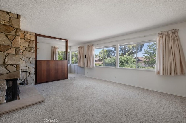8 Coveview Dr, Rancho Palos Verdes, CA 90275 - unfurnished living room with a textured ceiling, carpet flooring, and a stone fireplace