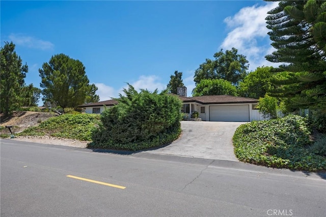 8 Coveview Dr, Rancho Palos Verdes, CA 90275 - view of front facade with a chimney, an attached garage, and concrete driveway