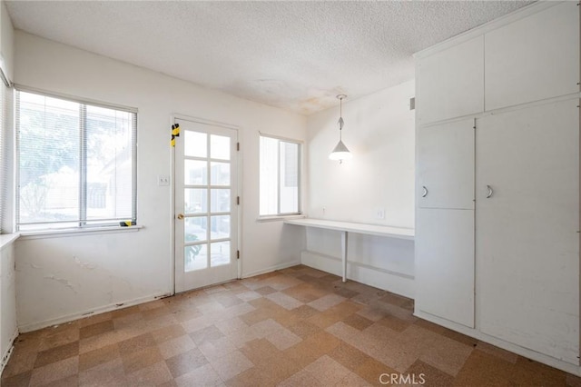 8 Coveview Dr, Rancho Palos Verdes, CA 90275 - unfurnished dining area featuring plenty of natural light, light floors, and a textured ceiling