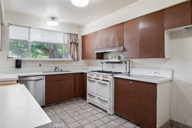 8 Coveview Dr, Rancho Palos Verdes, CA 90275 - kitchen with stainless steel dishwasher, double oven range, under cabinet range hood, light countertops, and light tile patterned flooring