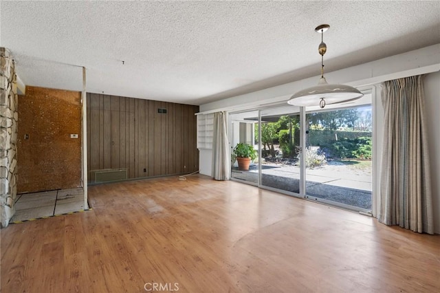 8 Coveview Dr, Rancho Palos Verdes, CA 90275 - spare room featuring light wood finished floors, a textured ceiling, and wood walls
