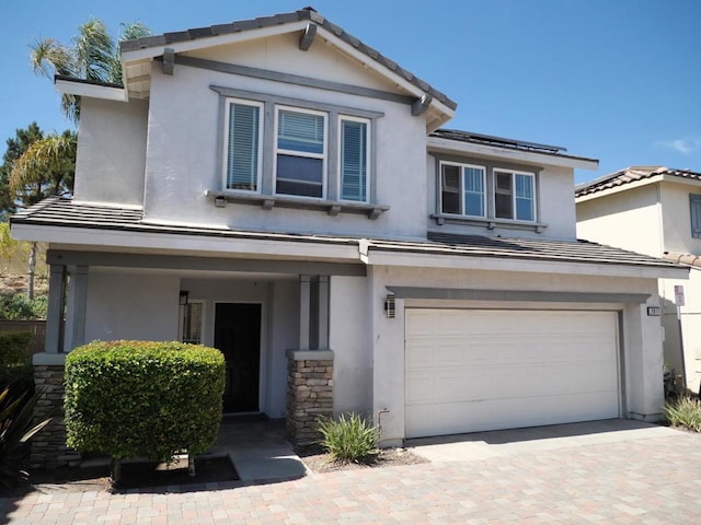 2811 Bear Valley Rd, Chula Vista, CA 91915 - view of front of house featuring an attached garage, stucco siding, a tile roof, and decorative driveway