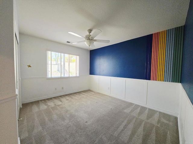 2811 Bear Valley Rd, Chula Vista, CA 91915 - unfurnished room featuring a wainscoted wall, a ceiling fan, carpet flooring, and wallpapered walls