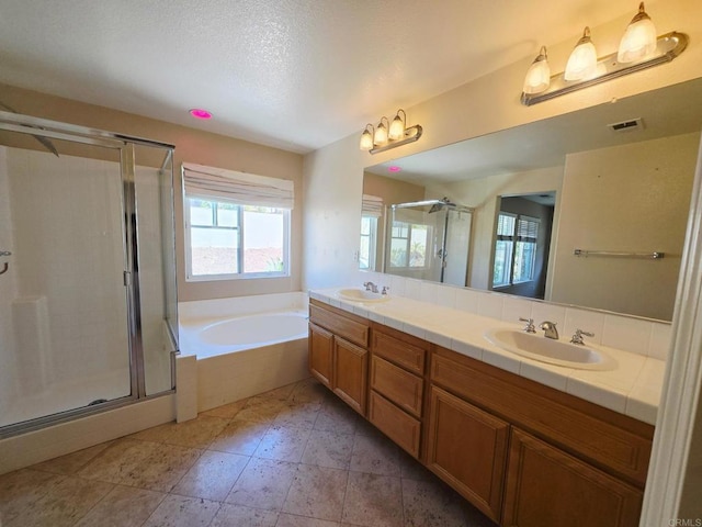 2811 Bear Valley Rd, Chula Vista, CA 91915 - bathroom with a garden tub, double vanity, a stall shower, a textured ceiling, and tile patterned flooring