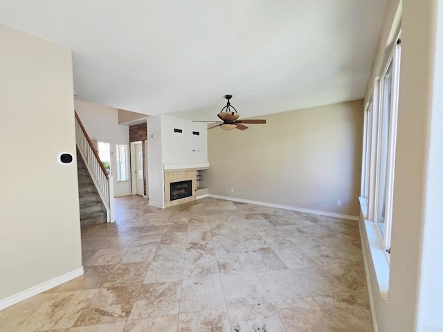 2811 Bear Valley Rd, Chula Vista, CA 91915 - unfurnished living room featuring ceiling fan, stairs, a fireplace, and light stone finish floors
