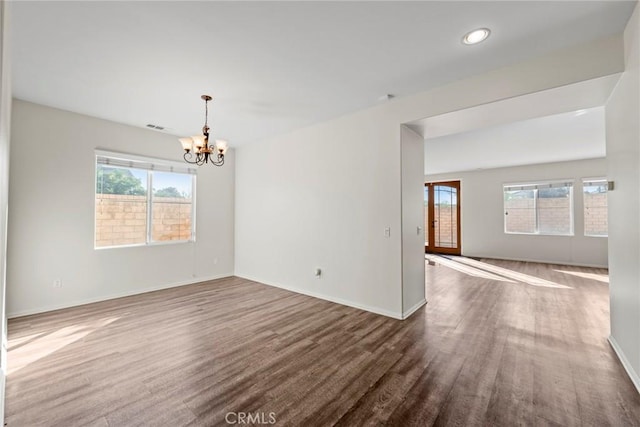 27132 Golden Field Ct, Moreno Valley, CA 92555 - unfurnished room featuring a chandelier, dark wood-style floors, healthy amount of natural light, and recessed lighting