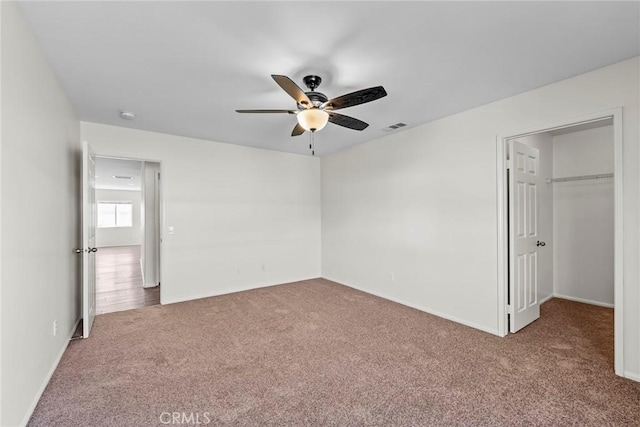 27132 Golden Field Ct, Moreno Valley, CA 92555 - unfurnished bedroom featuring carpet floors, a walk in closet, and a ceiling fan