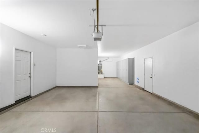 27132 Golden Field Ct, Moreno Valley, CA 92555 - garage featuring a garage door opener and baseboards