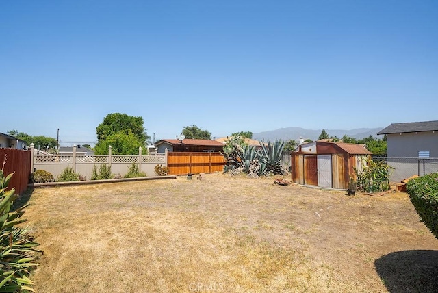 207 N Pasadena Ave, Azusa, CA 91702 - fenced backyard with a storage unit and a mountain view