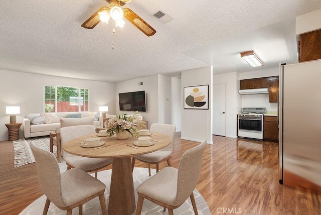 207 N Pasadena Ave, Azusa, CA 91702 - dining space with a textured ceiling, a ceiling fan, and light wood finished floors
