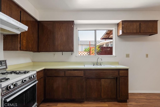 207 N Pasadena Ave, Azusa, CA 91702 - kitchen featuring white range with gas stovetop, extractor fan, light countertops, wood finished floors, and dark brown cabinets