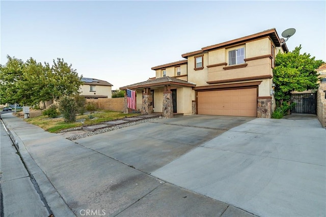2322 Carolyn Dr, Palmdale, CA 93551 - view of front of home featuring an attached garage, stucco siding, concrete driveway, and stone siding
