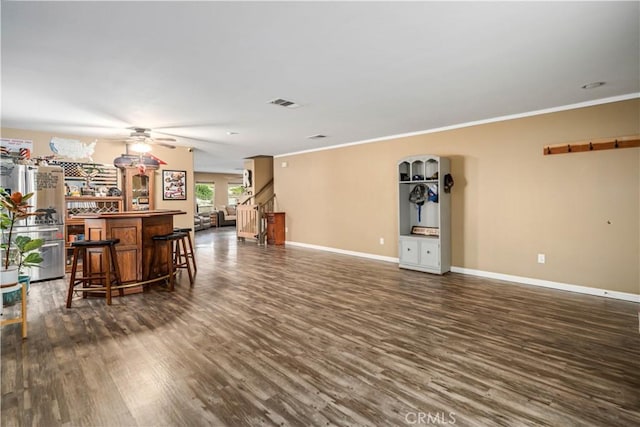 2322 Carolyn Dr, Palmdale, CA 93551 - living area featuring a bar, dark wood-style floors, a ceiling fan, and crown molding