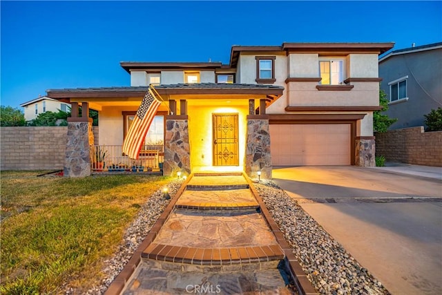 2322 Carolyn Dr, Palmdale, CA 93551 - view of front of home with an attached garage, stucco siding, concrete driveway, covered porch, and stone siding