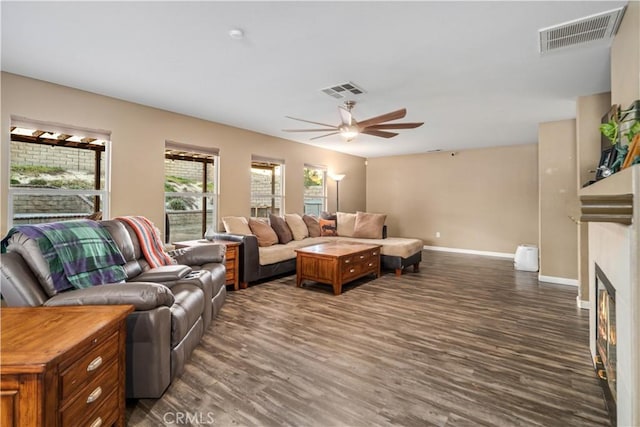 2322 Carolyn Dr, Palmdale, CA 93551 - living area with a ceiling fan, dark wood-style flooring, and a glass covered fireplace