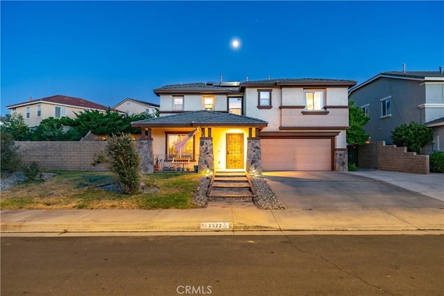 2322 Carolyn Dr, Palmdale, CA 93551 - prairie-style home with an attached garage, roof mounted solar panels, concrete driveway, stucco siding, and stone siding