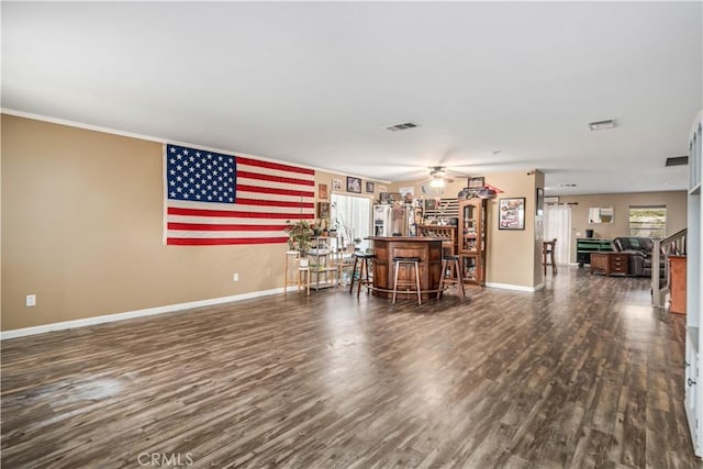 2322 Carolyn Dr, Palmdale, CA 93551 - living area featuring wood finished floors, ceiling fan, a bar, and ornamental molding