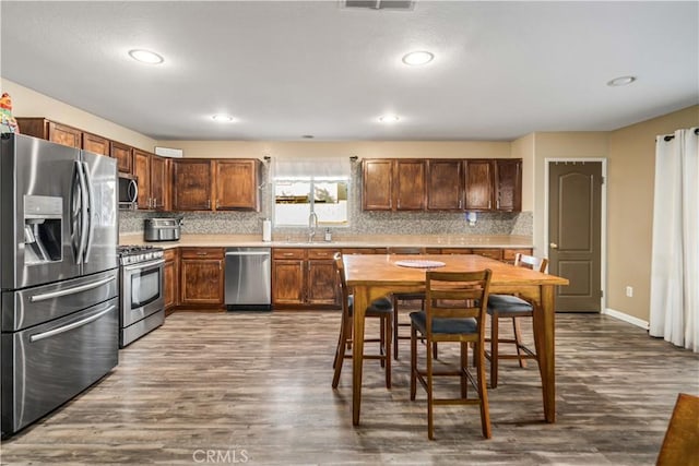 2322 Carolyn Dr, Palmdale, CA 93551 - kitchen featuring appliances with stainless steel finishes, dark wood-style flooring, backsplash, and recessed lighting