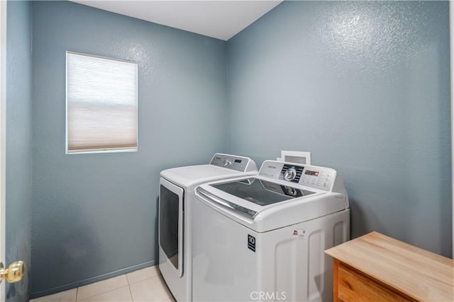 2322 Carolyn Dr, Palmdale, CA 93551 - laundry room with washing machine and dryer, light tile patterned floors, and a textured wall