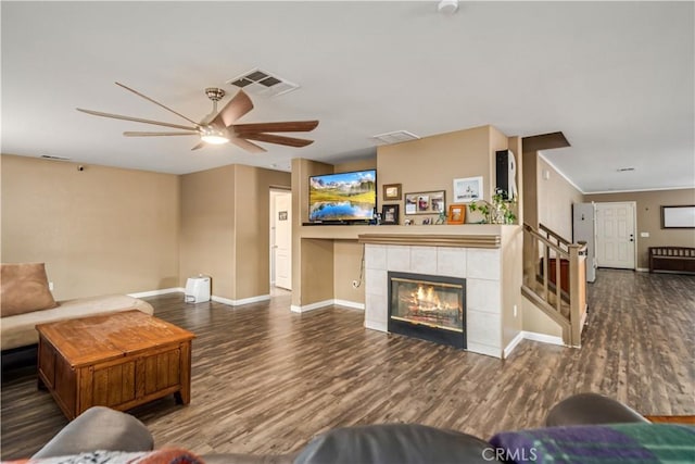 2322 Carolyn Dr, Palmdale, CA 93551 - living room featuring wood finished floors, a ceiling fan, a fireplace, and stairs