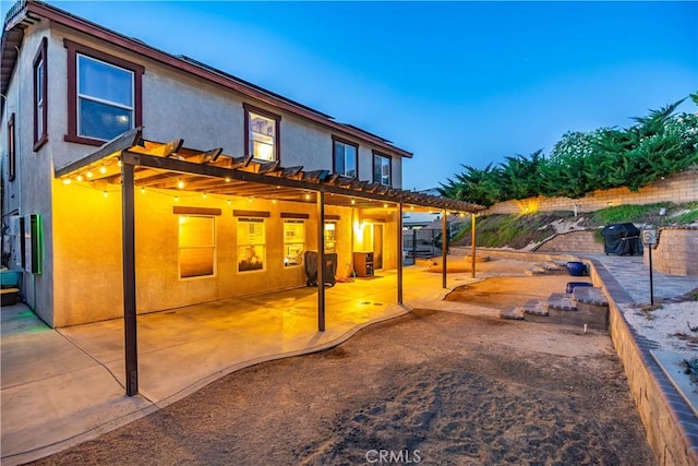 2322 Carolyn Dr, Palmdale, CA 93551 - back of property with stucco siding, a patio area, a pergola, and a fenced backyard