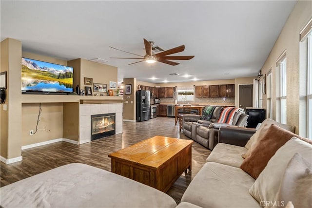 2322 Carolyn Dr, Palmdale, CA 93551 - living area featuring ceiling fan, dark wood finished floors, a tiled fireplace, and recessed lighting