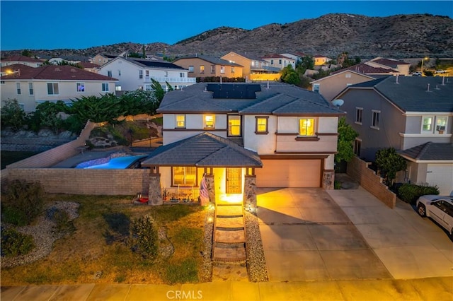 2322 Carolyn Dr, Palmdale, CA 93551 - traditional-style home with a residential view, roof mounted solar panels, a garage, a mountain view, and stucco siding