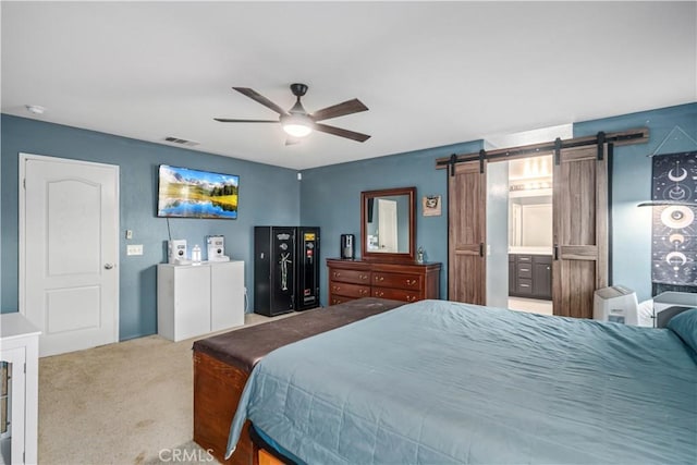 2322 Carolyn Dr, Palmdale, CA 93551 - carpeted bedroom with a barn door and ceiling fan