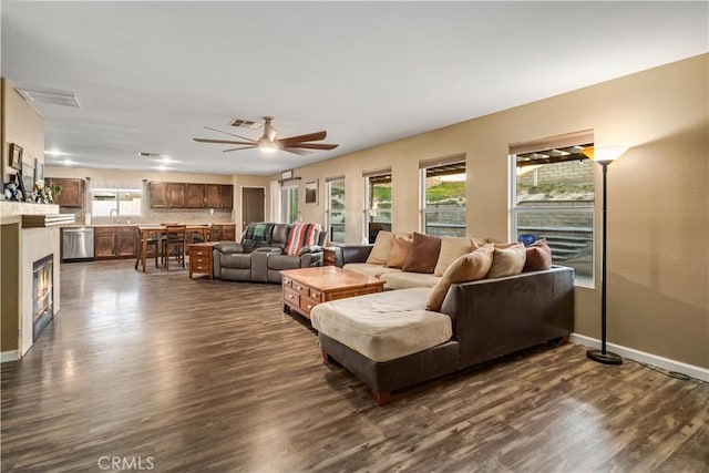 2322 Carolyn Dr, Palmdale, CA 93551 - living area featuring healthy amount of natural light, a ceiling fan, and dark wood-style flooring