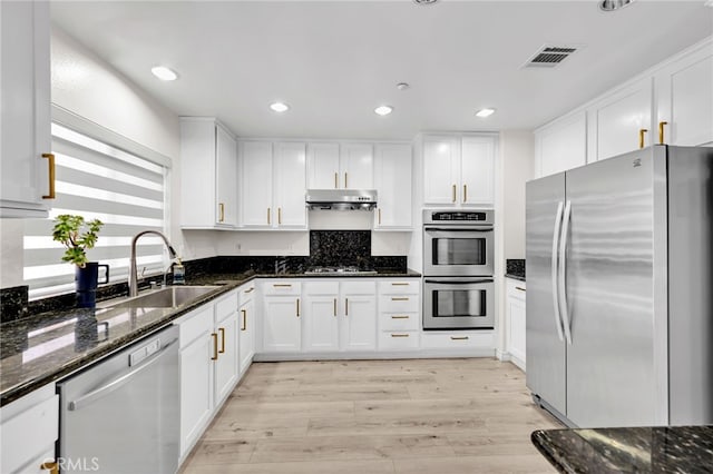 3470 E Temple Way, West Covina, CA 91791 - kitchen featuring stainless steel appliances, light wood-style floors, white cabinetry, dark stone countertops, and recessed lighting