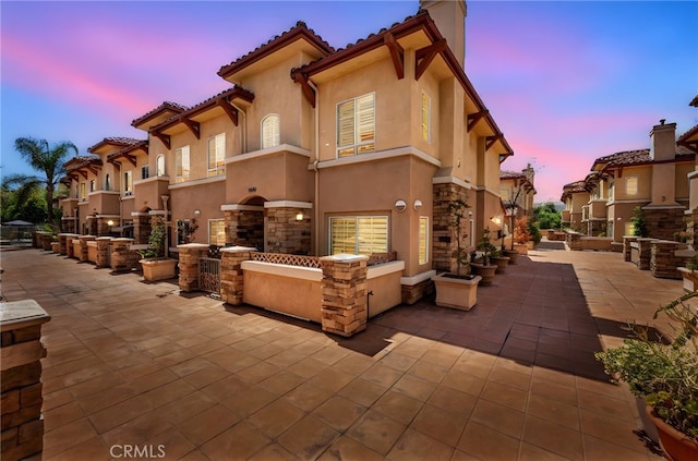 3470 E Temple Way, West Covina, CA 91791 - view of front of property featuring a patio, stucco siding, stone siding, a chimney, and a tiled roof