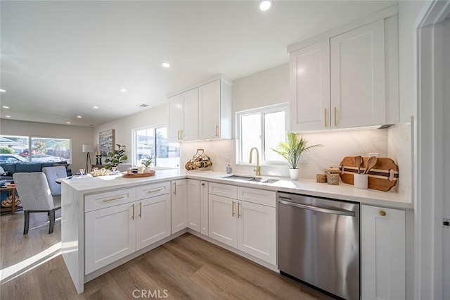482 Mountain View St, Altadena, CA 91001 - kitchen with stainless steel dishwasher, a peninsula, white cabinetry, light wood-style floors, and light countertops
