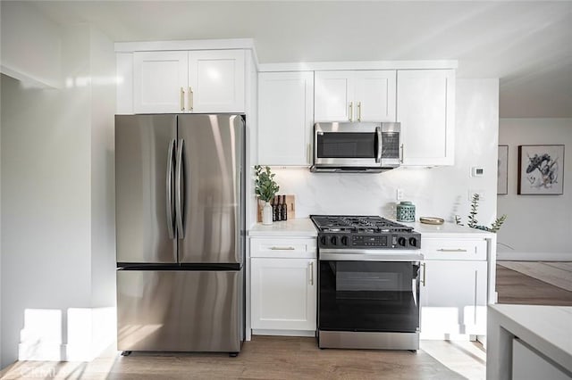 482 Mountain View St, Altadena, CA 91001 - kitchen featuring stainless steel appliances, light countertops, white cabinetry, and light wood-style floors