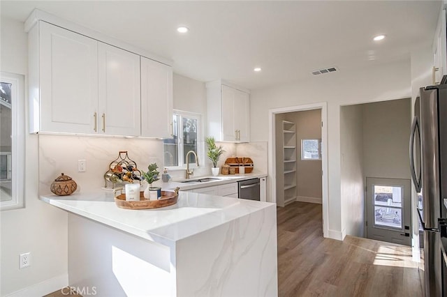 482 Mountain View St, Altadena, CA 91001 - kitchen featuring appliances with stainless steel finishes, light wood-style floors, white cabinets, healthy amount of natural light, and recessed lighting