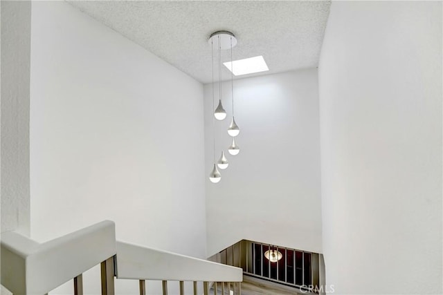 2620 W Grand Ave Unit E, Alhambra, CA 91801 - stairs featuring a textured ceiling, a skylight, and wood finished floors