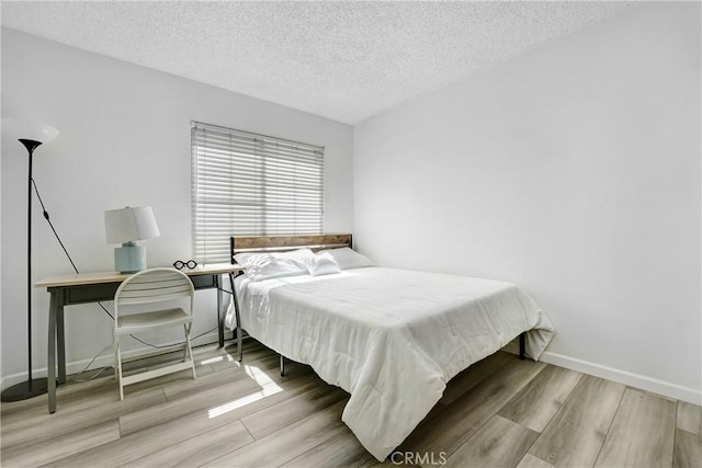2620 W Grand Ave Unit E, Alhambra, CA 91801 - bedroom featuring a textured ceiling and wood finished floors