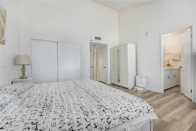 2620 W Grand Ave Unit E, Alhambra, CA 91801 - bedroom with a towering ceiling, light wood finished floors, a closet, and ensuite bath