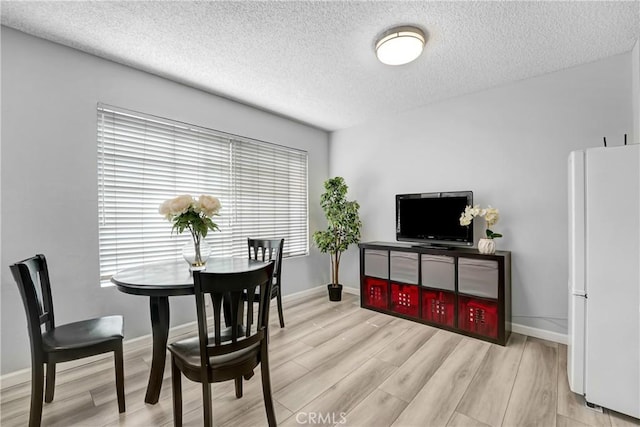2620 W Grand Ave Unit E, Alhambra, CA 91801 - dining space featuring a textured ceiling and light wood-style flooring