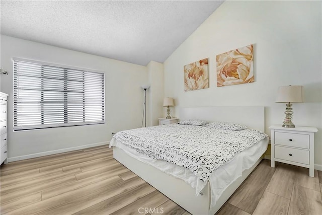 2620 W Grand Ave Unit E, Alhambra, CA 91801 - bedroom with light wood-type flooring, a textured ceiling, and vaulted ceiling