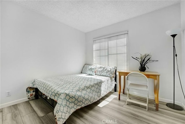 2620 W Grand Ave Unit E, Alhambra, CA 91801 - bedroom with wood finished floors and a textured ceiling