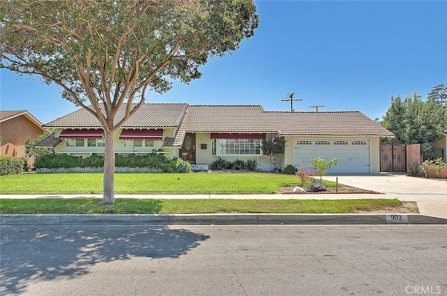 902 W Lucille Ave, West Covina, CA 91790 - view of front of house featuring a tiled roof, an attached garage, stucco siding, concrete driveway, and a gate